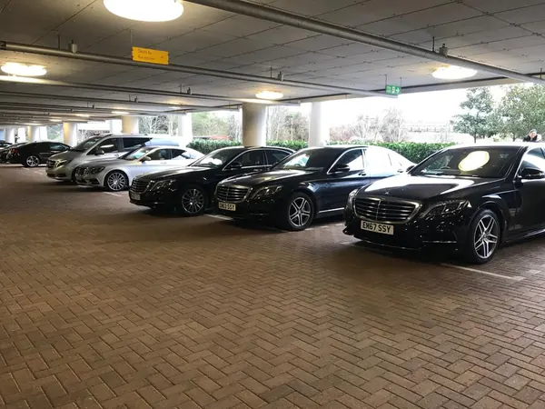 Line of black Mercedes S Class cars in a car park