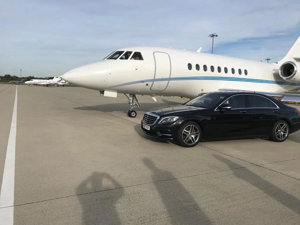 Mercedes S Class waiting beside a private jet