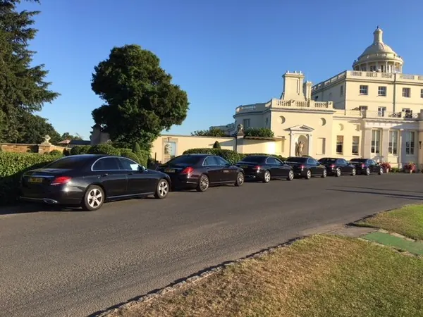 Line of Mercedes cars on the drive at Stoke Park
